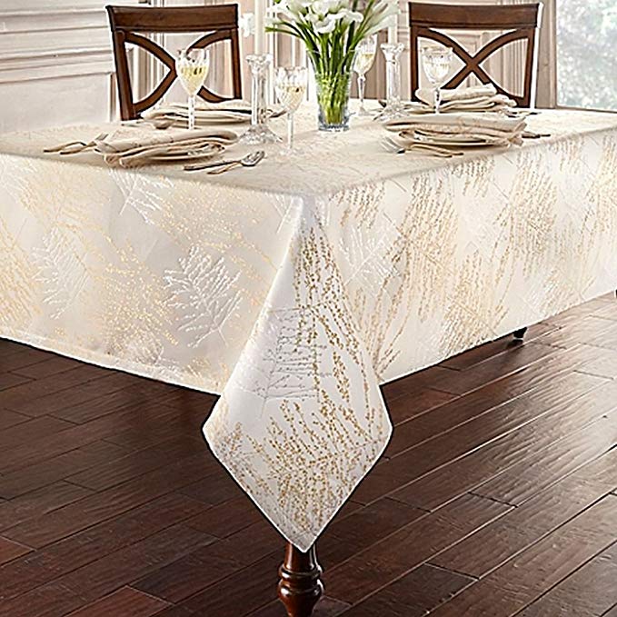 Linens Timber 70-Inch x 126-Inch Oblong Tablecloth in Gold/Silver, metallic trees printed over a woven jacquard textile create a luxurious ambiance among your fine china and glasses!